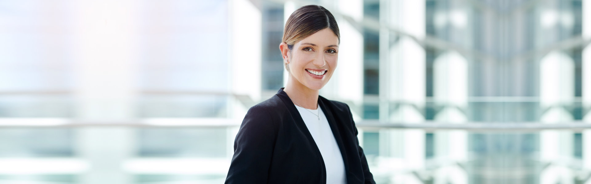 a woman in a business attire smiling